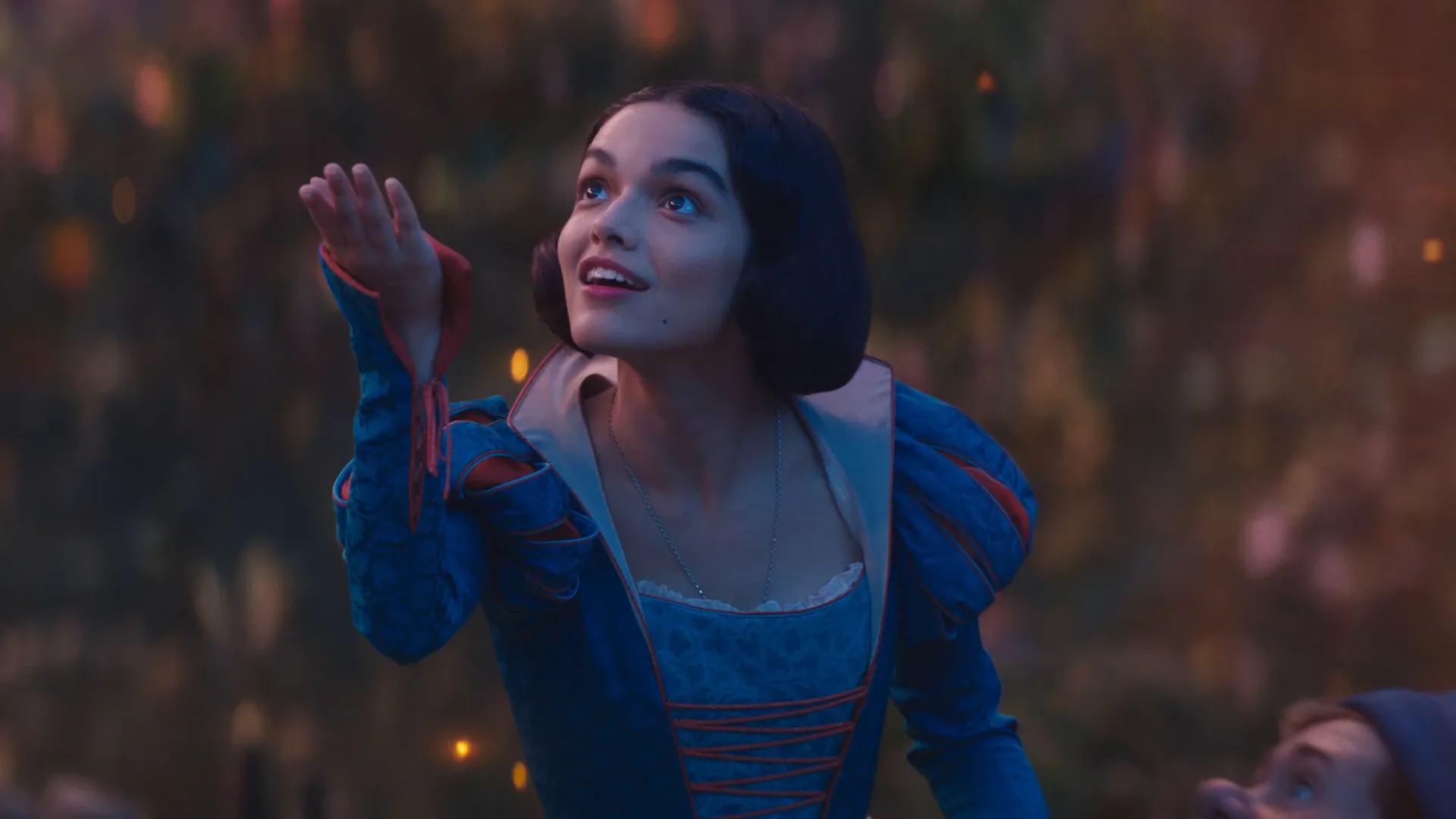 Snow White holding her hand up to the air.